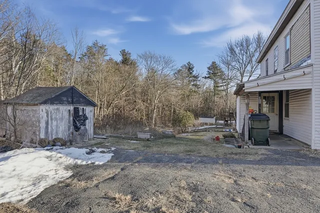 a view of a house with a yard covered in snow