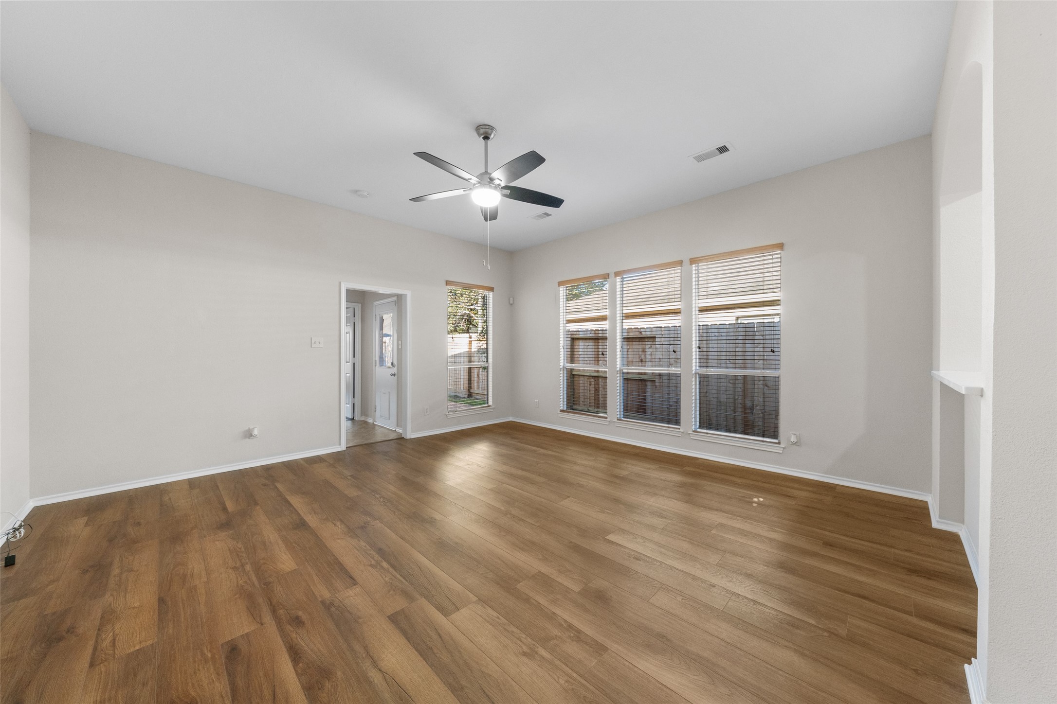 2443 Morgan Ridge Lane Spring, TX 77386 - Photo 12 of 26 a view of an empty room with a window and wooden floor
