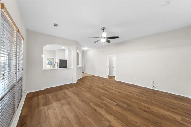 wooden floor in an empty room with a window