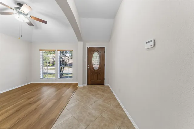 a view of a room with window and mirror