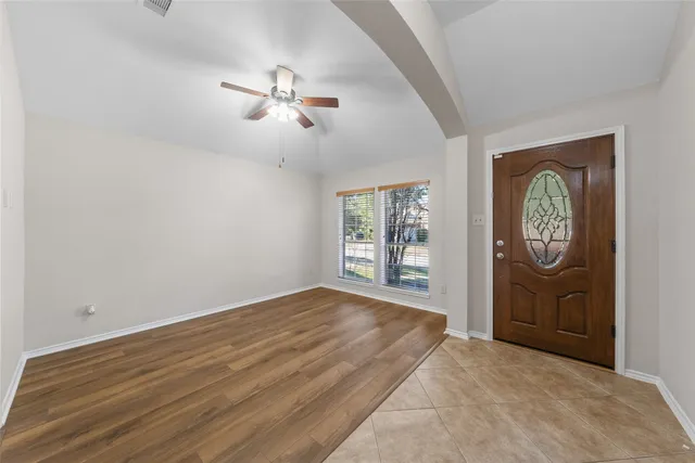 a view of empty room with a fan