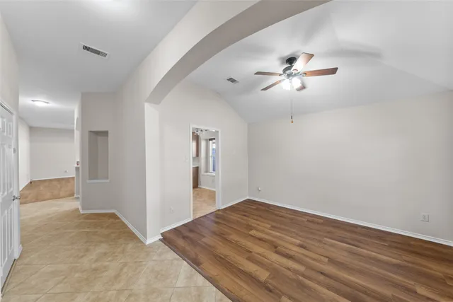 an empty room with fan and a ceiling fan