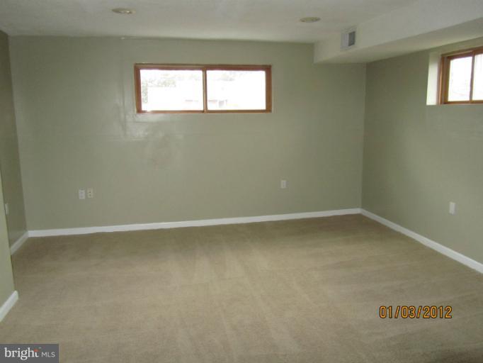 5803 Channing Road Springfield, VA 22150 - Photo 1 of 12 a view of an empty room with a window