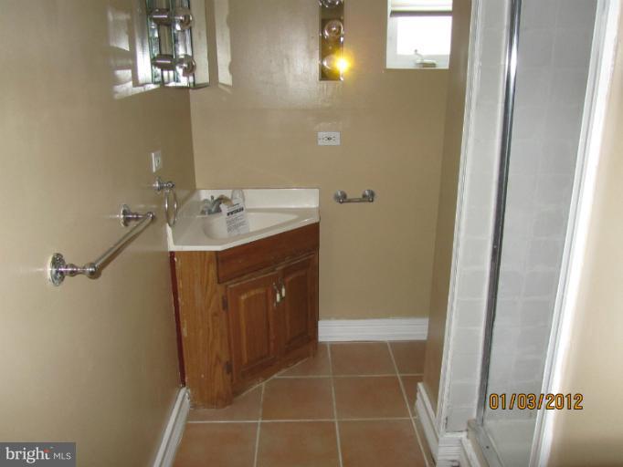 5803 Channing Road Springfield, VA 22150 - Photo 8 of 12 a bathroom with a sink a vanity and a mirror
