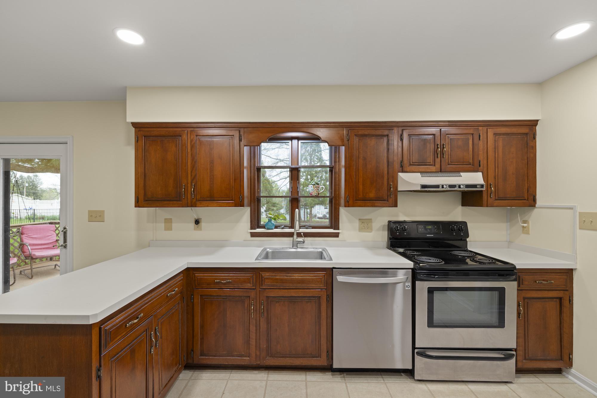 617 Heritage Drive Gettysburg, PA 17325 - Photo 14 of 56 a kitchen with granite countertop a stove a sink and a microwave