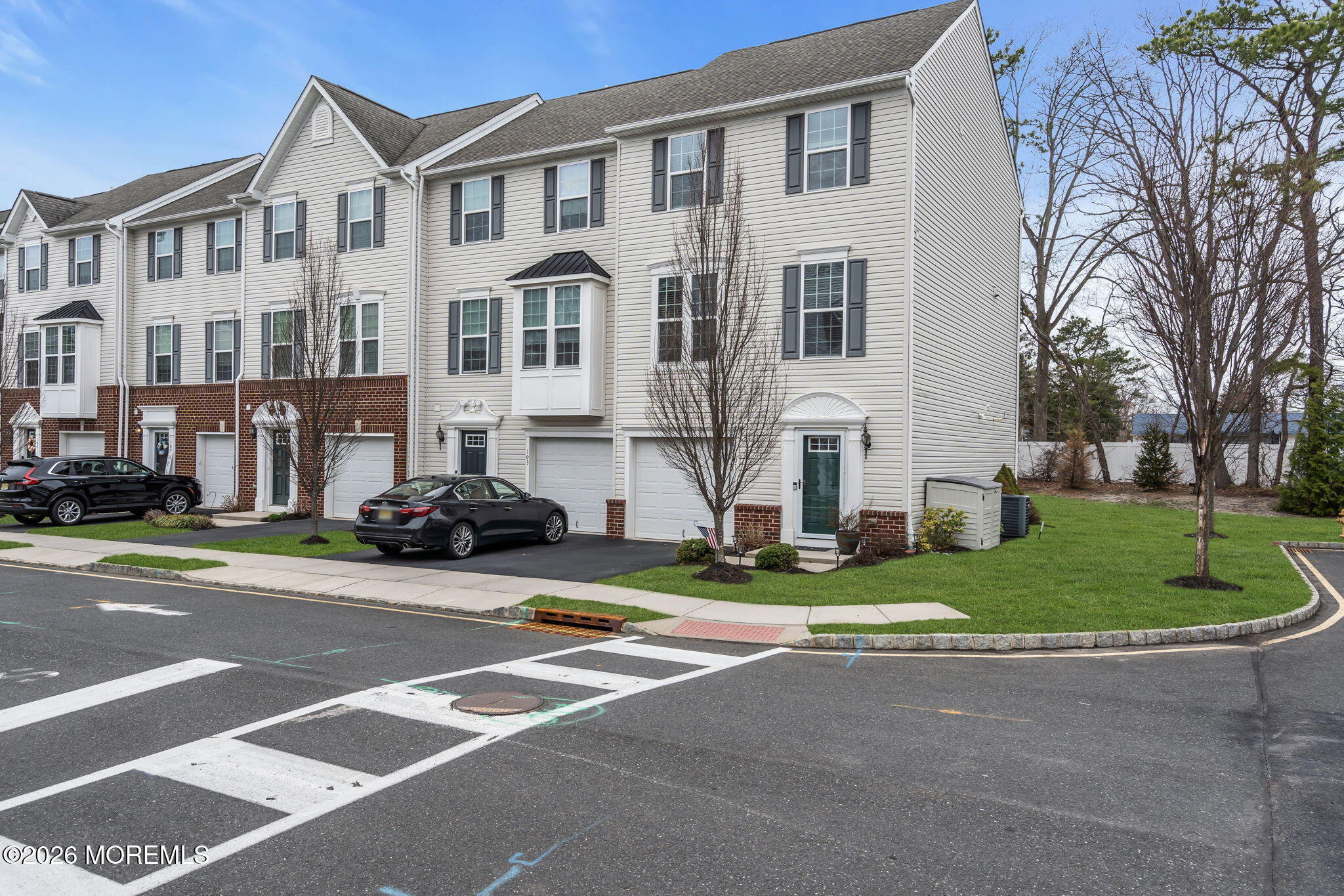 101 Spirit Way, Unit 301 Brick, NJ 08723 - Photo 1 of 52 a view of a parked cars in front of a building
