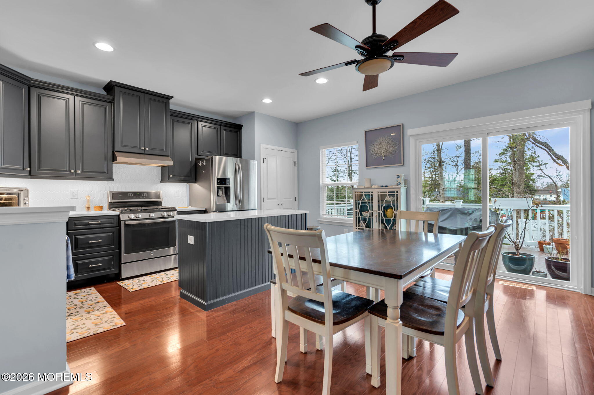 101 Spirit Way, Unit 301 Brick, NJ 08723 - Photo 21 of 52 a kitchen with stainless steel appliances granite countertop a stove a refrigerator a sink a dining table and chairs with wooden floor