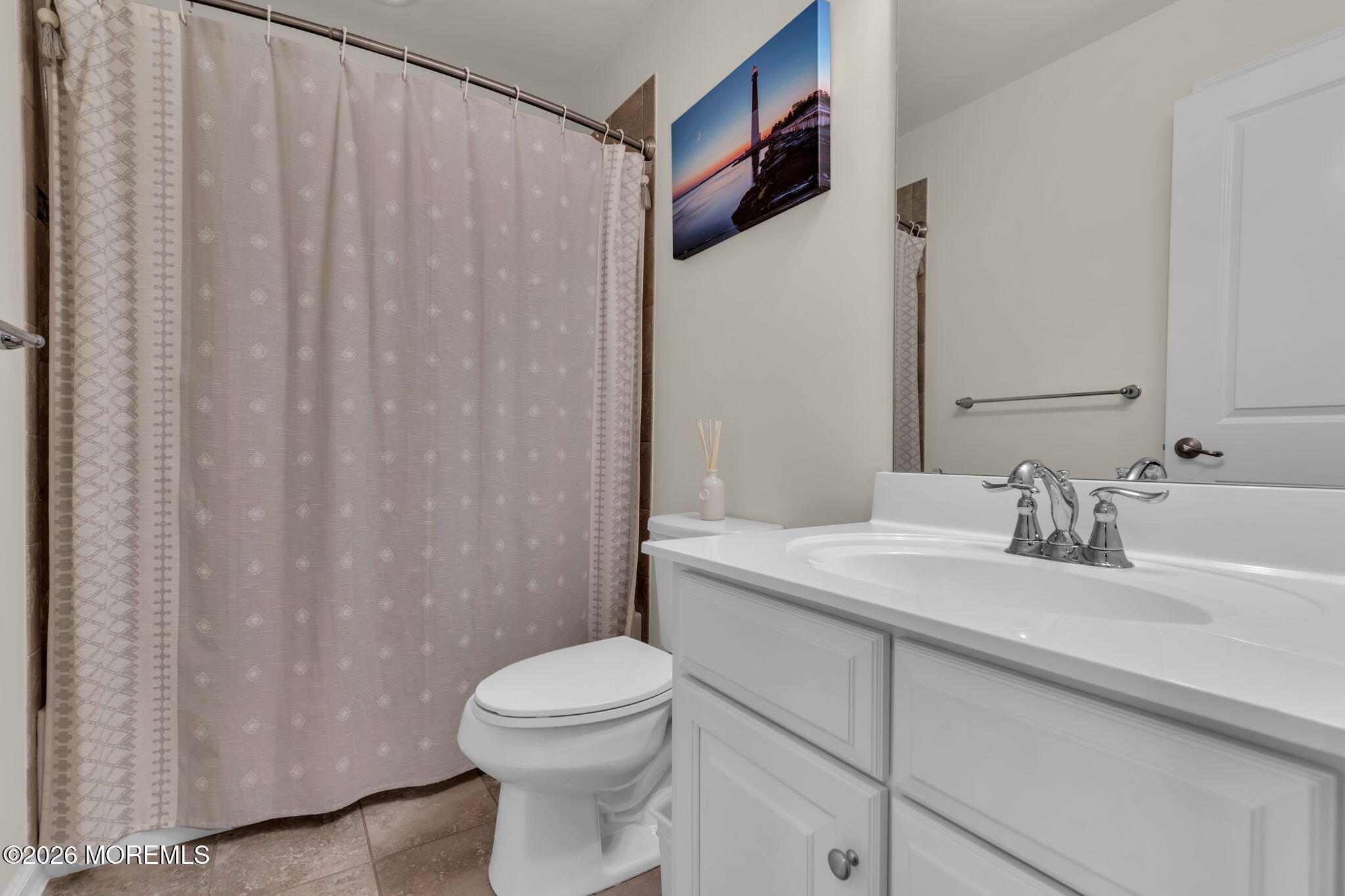 101 Spirit Way, Unit 301 Brick, NJ 08723 - Photo 33 of 52 a bathroom with a sink a toilet and shower curtain