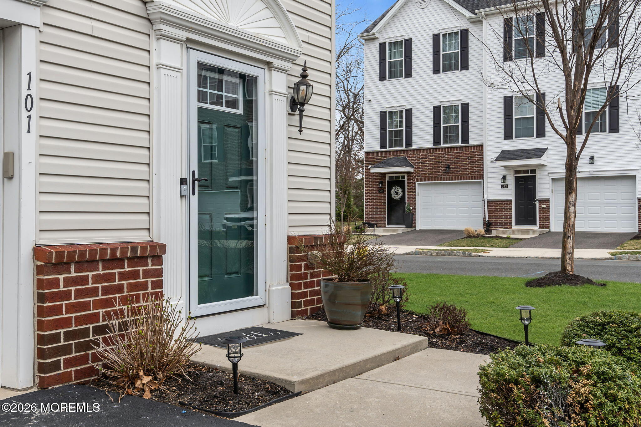101 Spirit Way, Unit 301 Brick, NJ 08723 - Photo 38 of 52 a front view of a house with garden