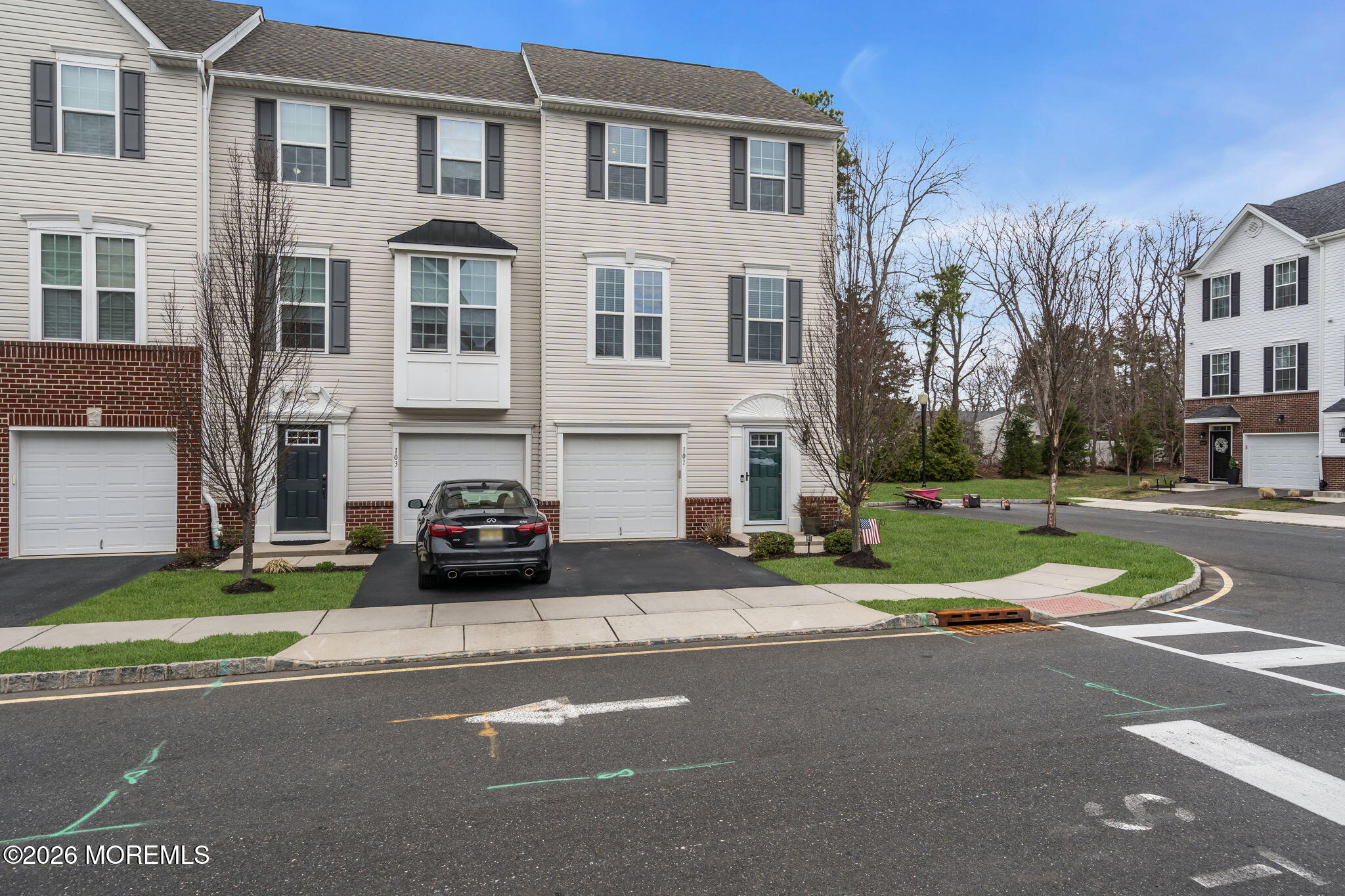 101 Spirit Way, Unit 301 Brick, NJ 08723 - Photo 40 of 52 a front view of a building with a garden and plants