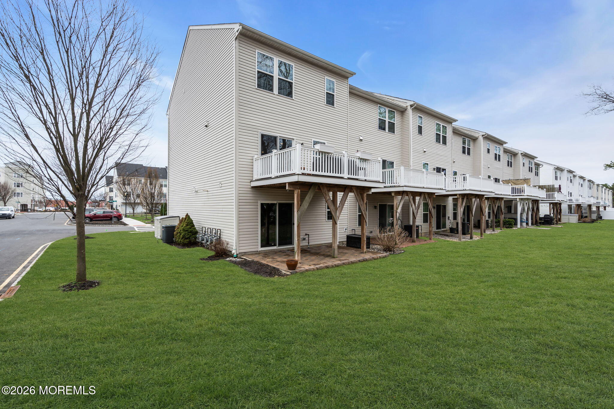 101 Spirit Way, Unit 301 Brick, NJ 08723 - Photo 43 of 52 a view of a white house with a big yard and large trees