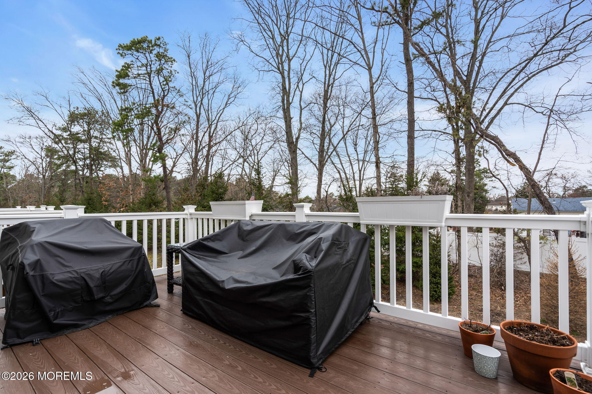 101 Spirit Way, Unit 301 Brick, NJ 08723 - Photo 50 of 52 a view of a roof deck with couches and wooden fence