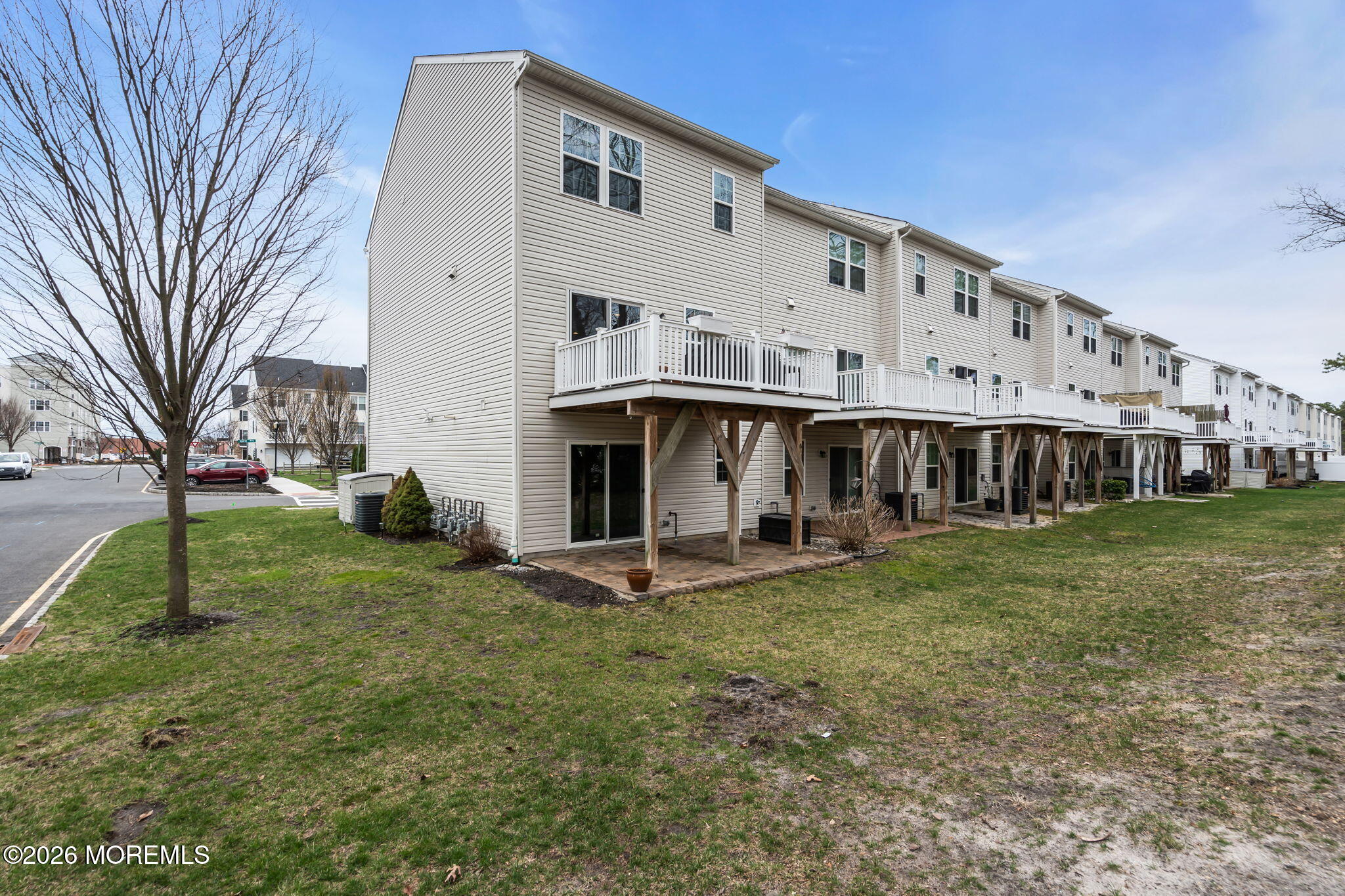 101 Spirit Way, Unit 301 Brick, NJ 08723 - Photo 51 of 52 a view of a white house with a big yard and large trees