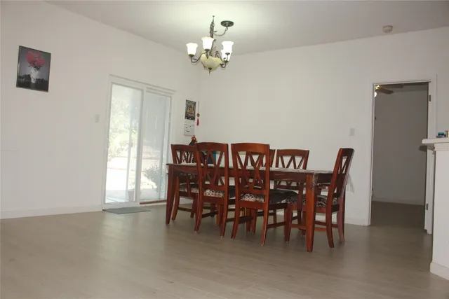 a view of a dining room with furniture and chandelier