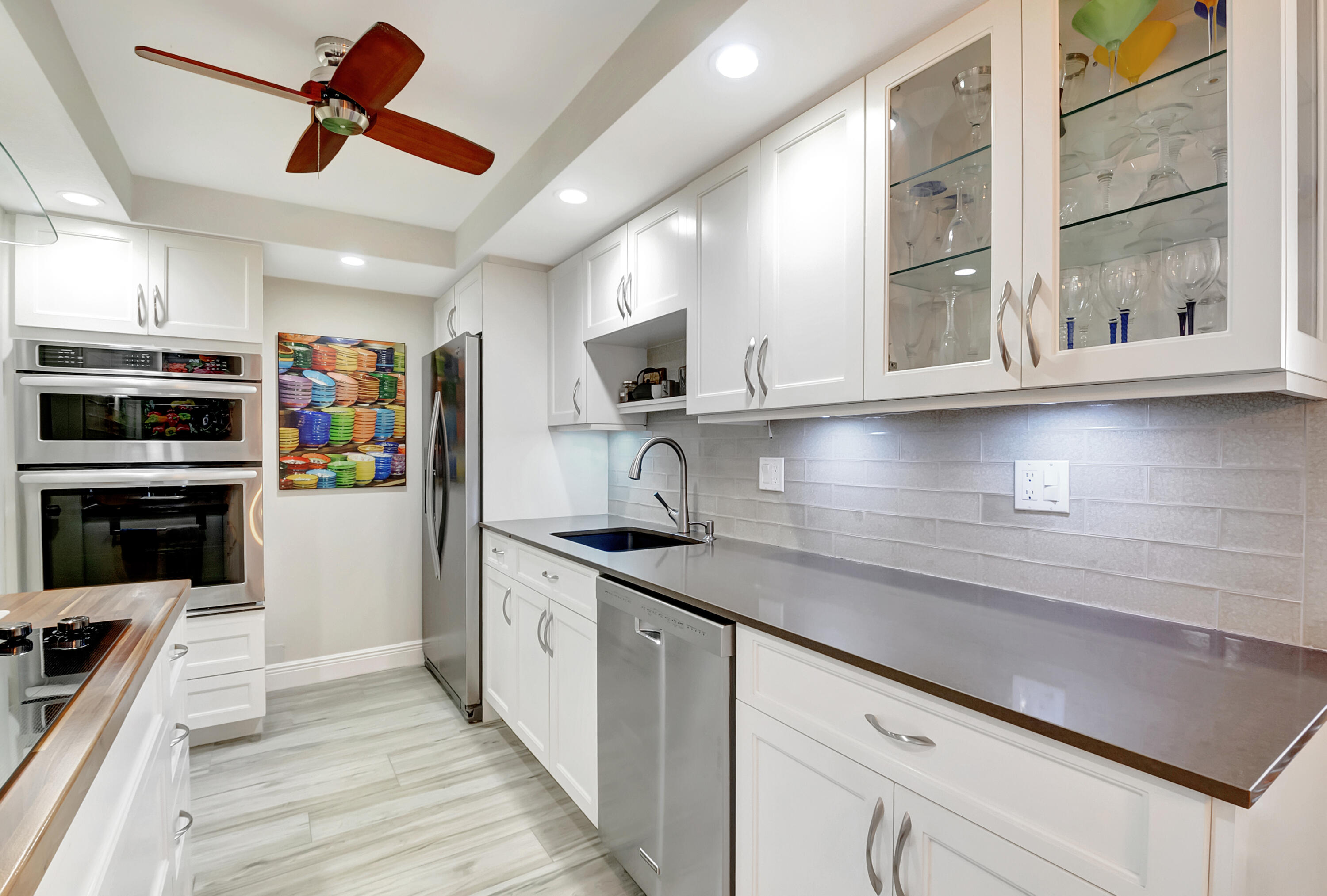 1523 Bridgewood Drive Boca Raton, FL 33434 - Photo 11 of 50 a kitchen with stainless steel appliances granite countertop a sink and a stove
