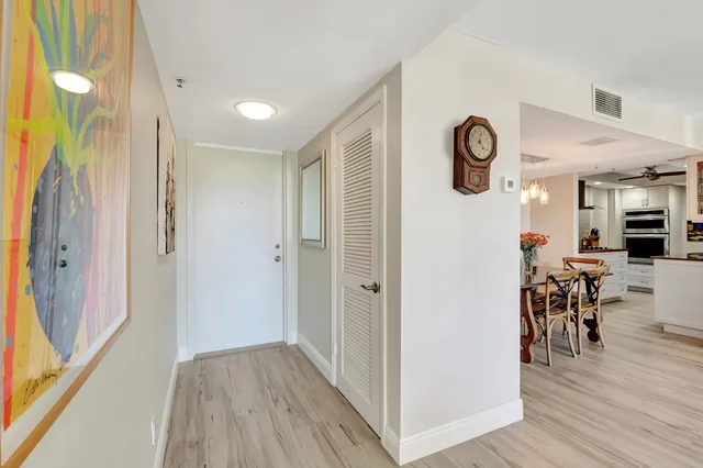 a view of a hallway to a livingroom and furniture