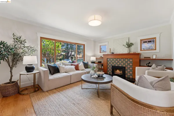 a living room with furniture a fireplace and a table