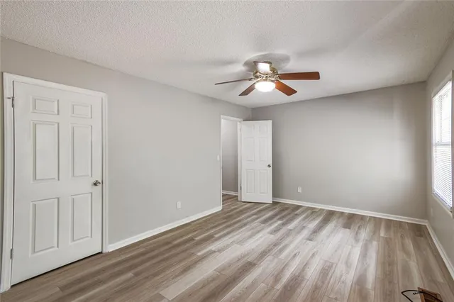 a view of room with hardwood floor and ceiling fan