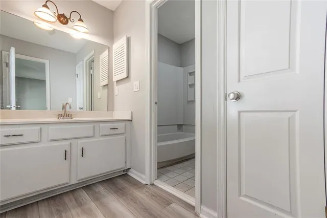 a bathroom with a double vanity sink and a mirror