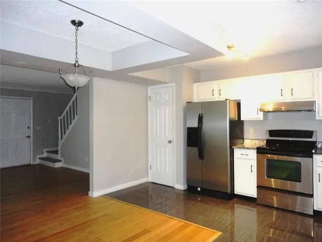 a kitchen with stainless steel appliances a refrigerator and a stove top oven