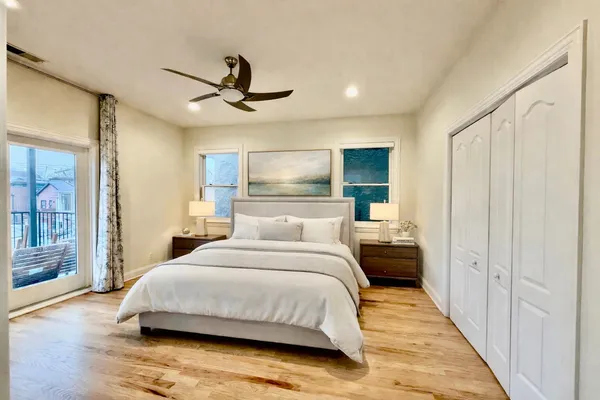 a bedroom with a bed and a chandelier