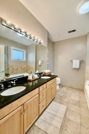 a large bathroom with a double vanity sink and a mirror