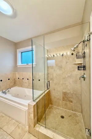 a bathroom with a bathtub and a shower