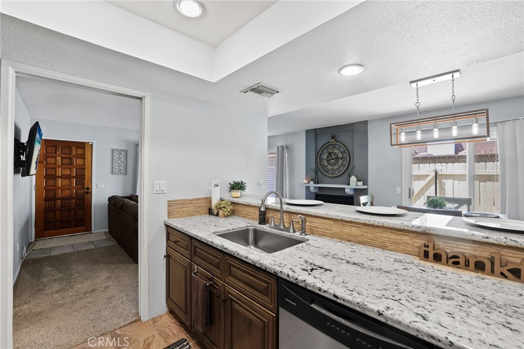 916 Ardmore Circle Redlands, CA 92374 - Photo 13 of 29 a kitchen with a sink a stove and cabinets