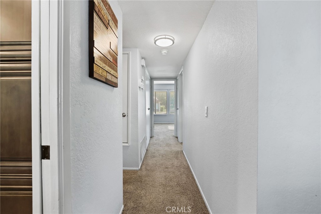 916 Ardmore Circle Redlands, CA 92374 - Photo 14 of 29 a view of a hallway with wooden floor and a bathroom