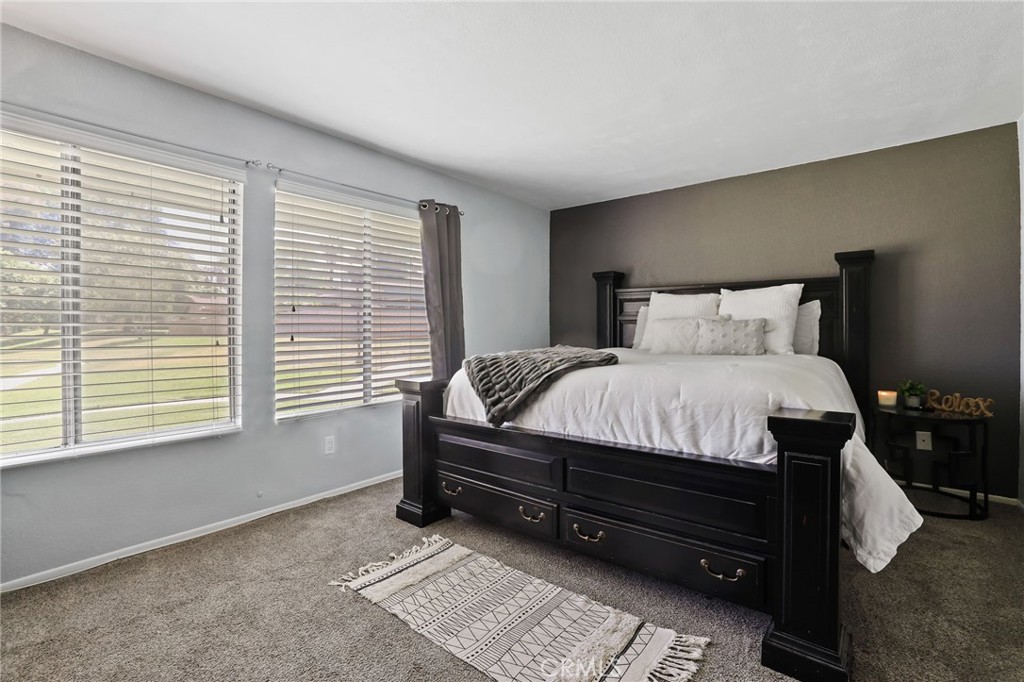 916 Ardmore Circle Redlands, CA 92374 - Photo 15 of 29 a bed sitting in a bedroom next to a window