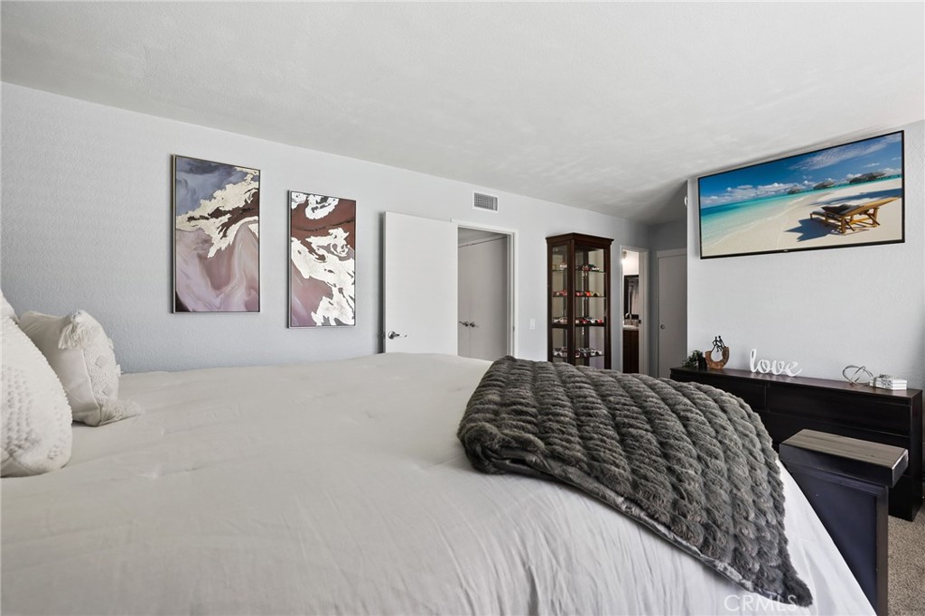 916 Ardmore Circle Redlands, CA 92374 - Photo 17 of 29 a bedroom with a large bed and a chandelier