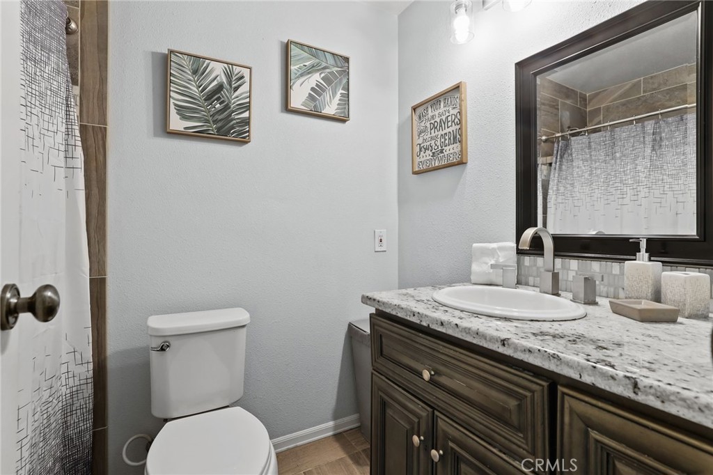 916 Ardmore Circle Redlands, CA 92374 - Photo 18 of 29 a bathroom with a granite countertop toilet sink and mirror
