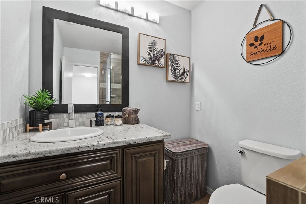 916 Ardmore Circle Redlands, CA 92374 - Photo 21 of 29 a bathroom with a granite countertop sink and a mirror
