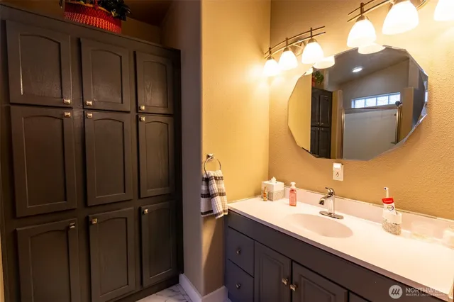 a bathroom with a sink vanity and a mirror