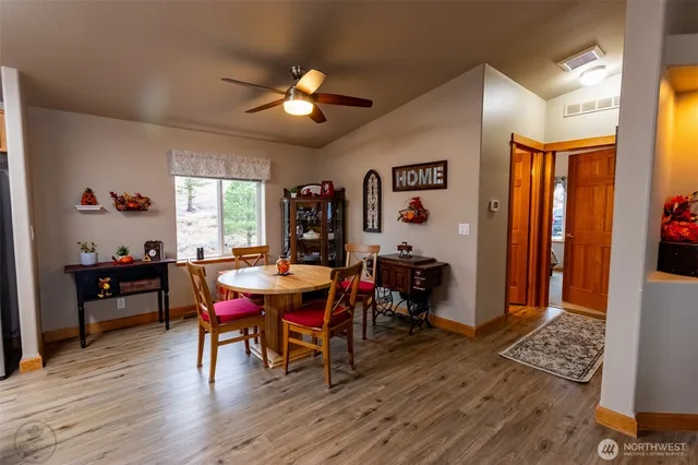 a view of a dining room with furniture and chandelier