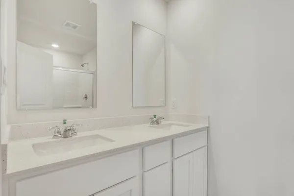 a bathroom with 2 sink and a mirror