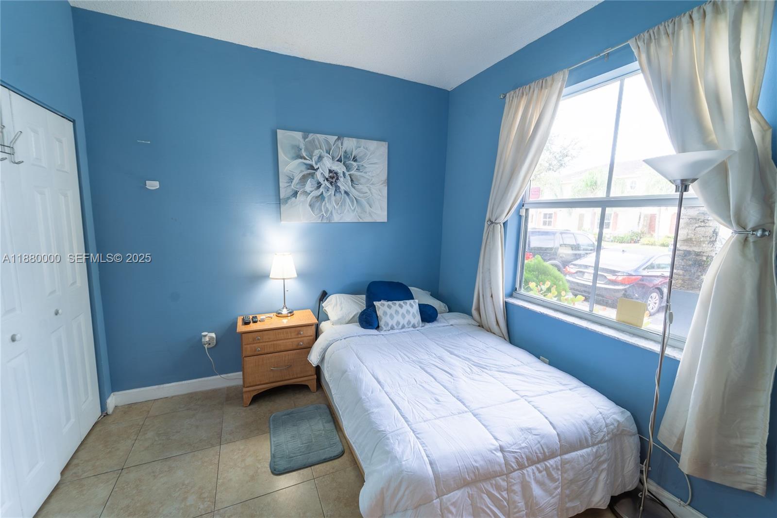 983 Northeast 42nd Place Homestead, FL 33033 - Photo 11 of 51 a bedroom with a bed and a large window