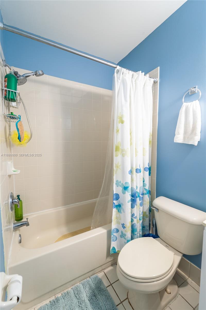 983 Northeast 42nd Place Homestead, FL 33033 - Photo 16 of 51 a white toilet sitting next to a bath tub a sink