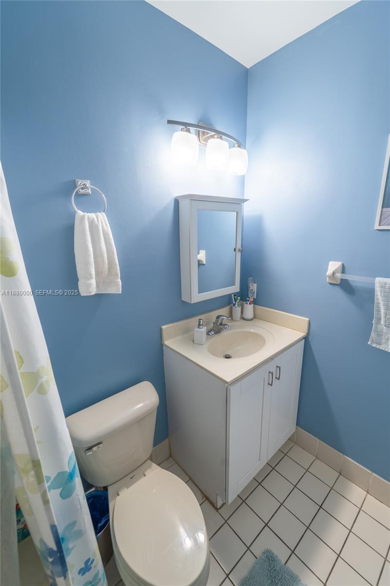 983 Northeast 42nd Place Homestead, FL 33033 - Photo 17 of 51 a bathroom with a sink toilet and mirror