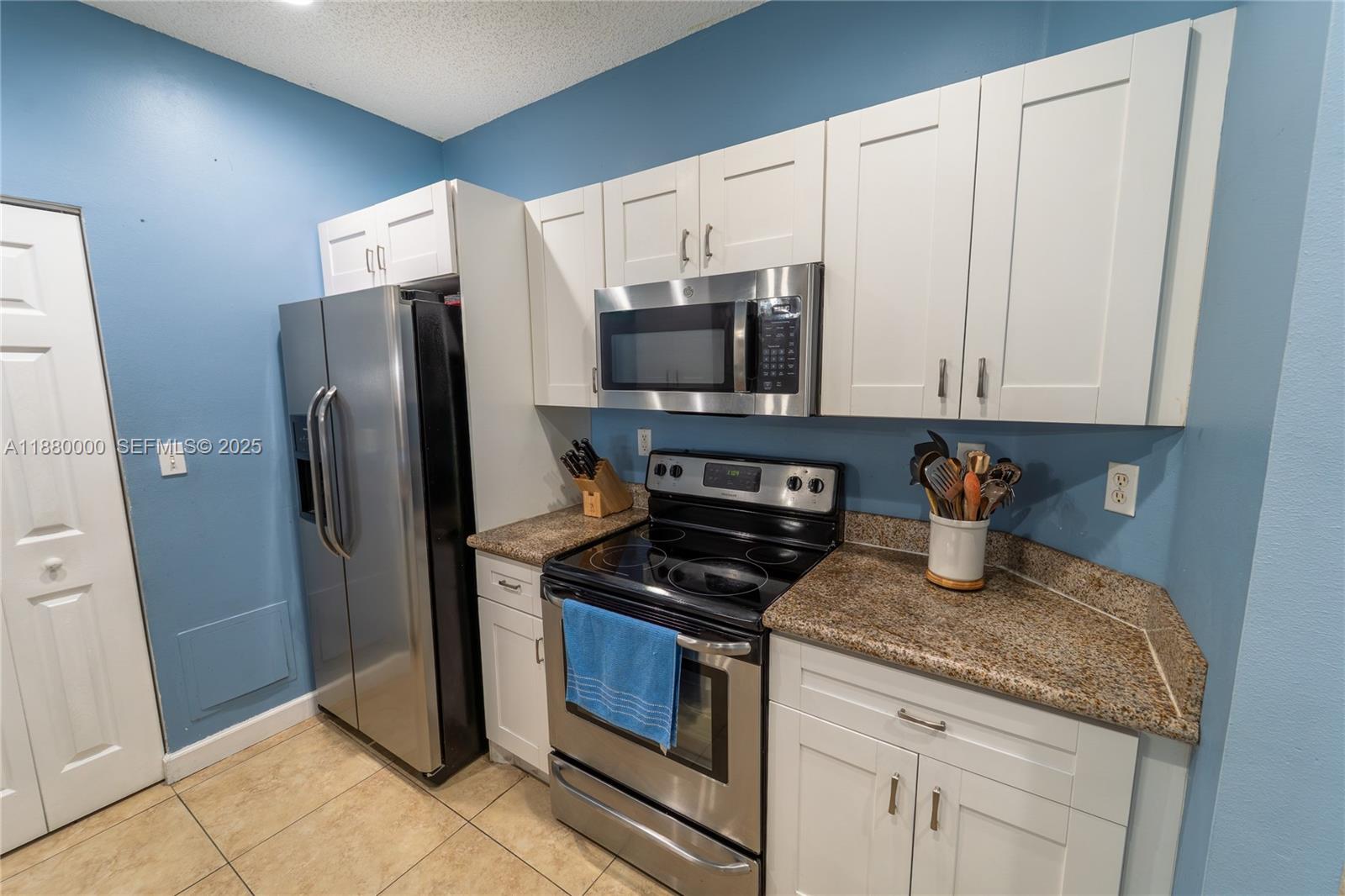983 Northeast 42nd Place Homestead, FL 33033 - Photo 21 of 51 a kitchen with granite countertop a refrigerator and a sink
