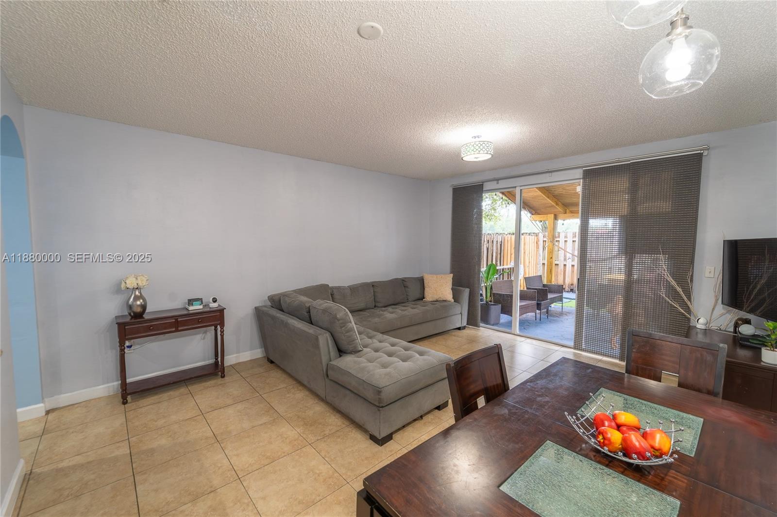 983 Northeast 42nd Place Homestead, FL 33033 - Photo 30 of 51 a living room with furniture and a flat screen tv