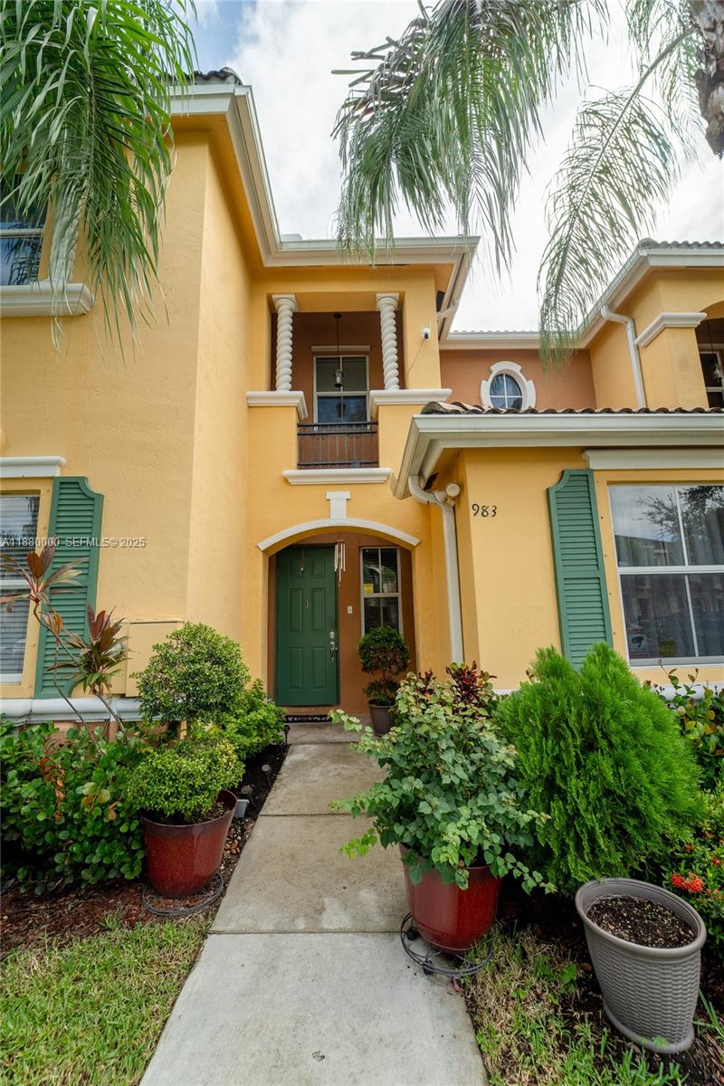 983 Northeast 42nd Place Homestead, FL 33033 - Photo 3 of 51 a front view of a house with garden