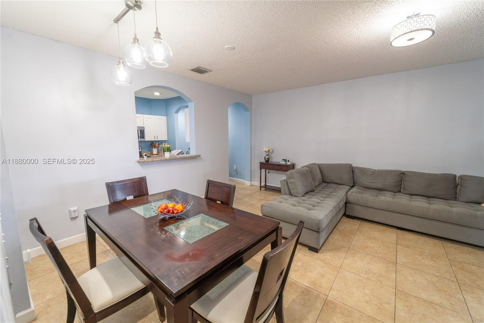 983 Northeast 42nd Place Homestead, FL 33033 - Photo 31 of 51 a living room with furniture and a chandelier