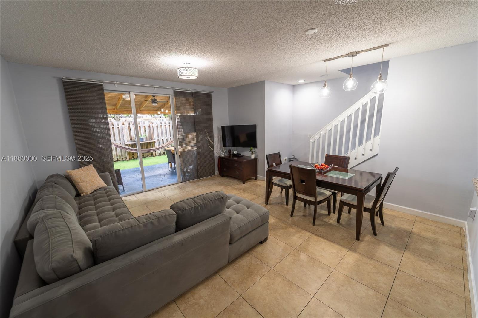 983 Northeast 42nd Place Homestead, FL 33033 - Photo 33 of 51 a living room with furniture and a flat screen tv