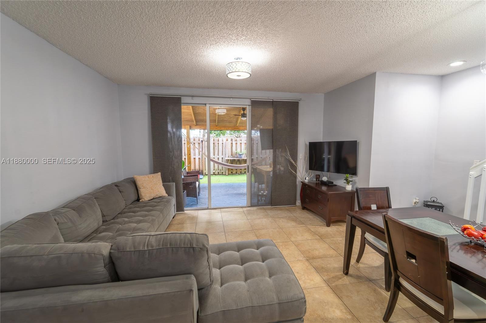 983 Northeast 42nd Place Homestead, FL 33033 - Photo 34 of 51 a living room with furniture and a flat screen tv