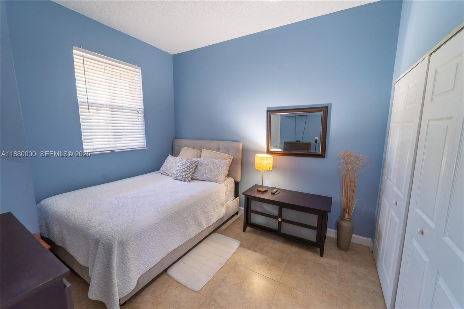 983 Northeast 42nd Place Homestead, FL 33033 - Photo 38 of 51 a bedroom with a bed and a window