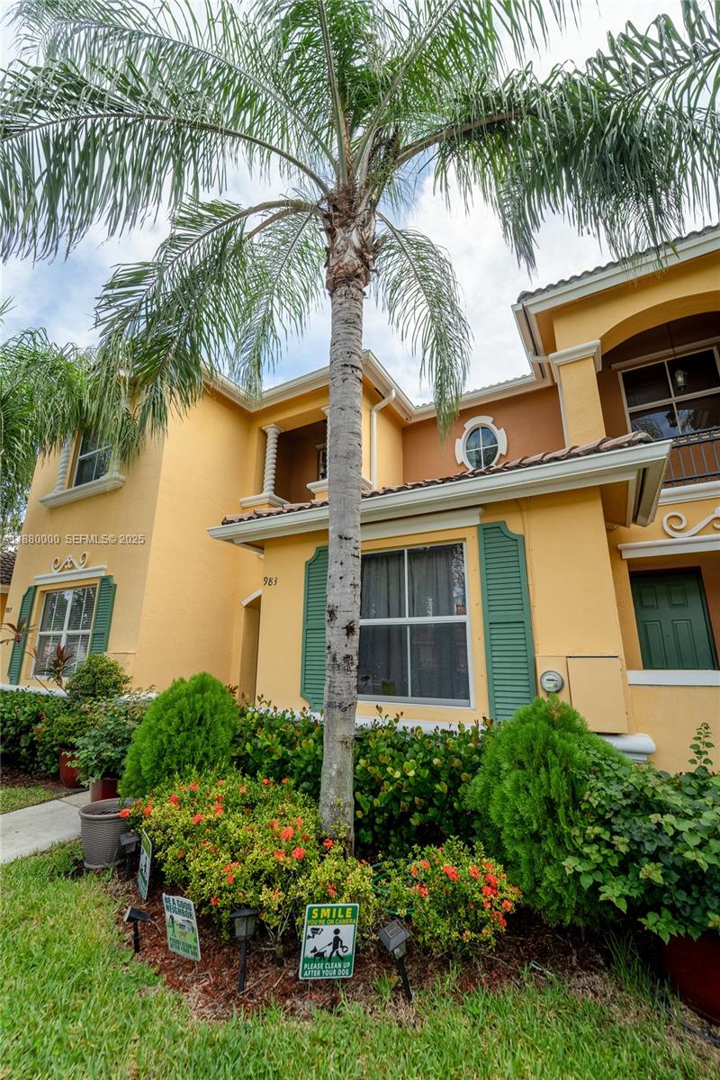 983 Northeast 42nd Place Homestead, FL 33033 - Photo 4 of 51 a front view of a house with a garden