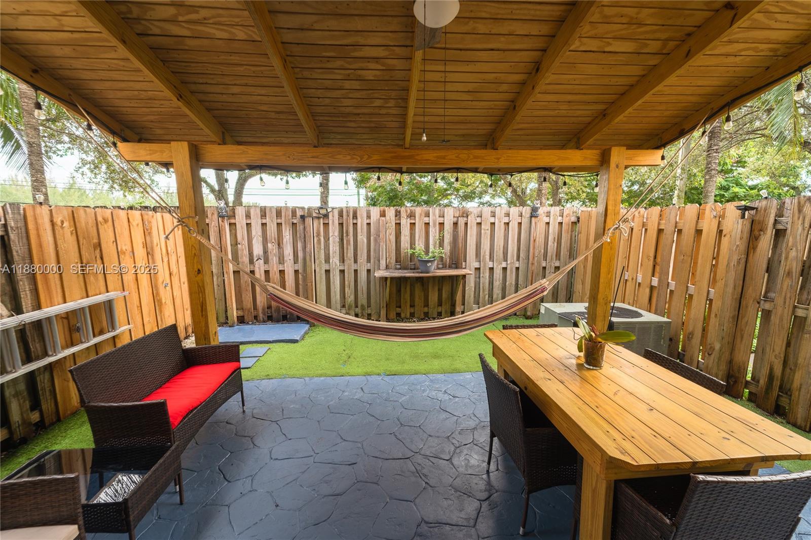 983 Northeast 42nd Place Homestead, FL 33033 - Photo 47 of 51 a backyard of a house with a garden and outdoor seating