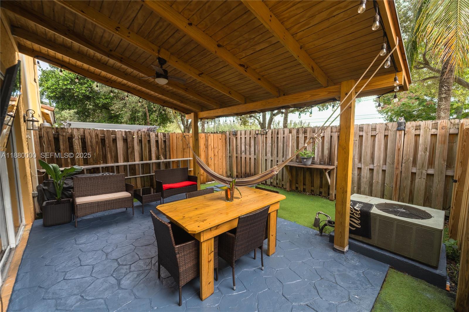 983 Northeast 42nd Place Homestead, FL 33033 - Photo 48 of 51 a backyard of a house with sofas table and chairs