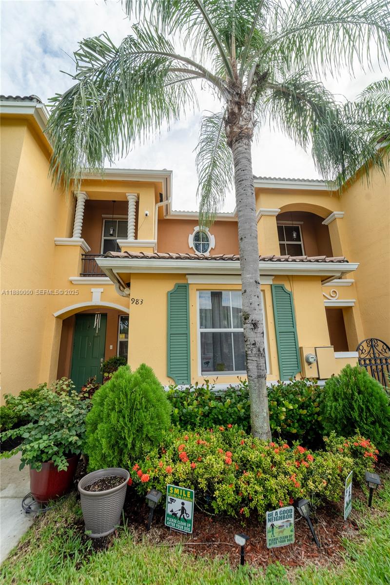 983 Northeast 42nd Place Homestead, FL 33033 - Photo 5 of 51 a front view of a house with a garden